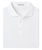 The Peter Millar Crown Comfort Polo, made from soft pima cotton, is neatly folded and features a collar with a classic three-button placket, plus a small neck tag.