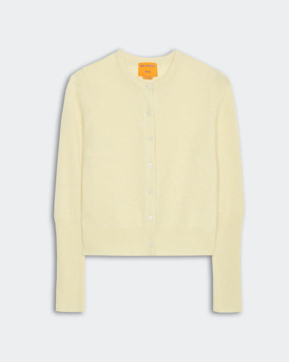 The Jane Cardigan by Guest in Residence is a light yellow, long-sleeve, button-up Jersey Stitch style with ribbed cuffs and hem, shown flat on a plain background.