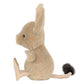 The Jellycat Jerboa is a plush toy featuring large ears, a round body, short limbs, and a long fluffy-tipped tail, shown in profile on a white background—perfect for cuddling.