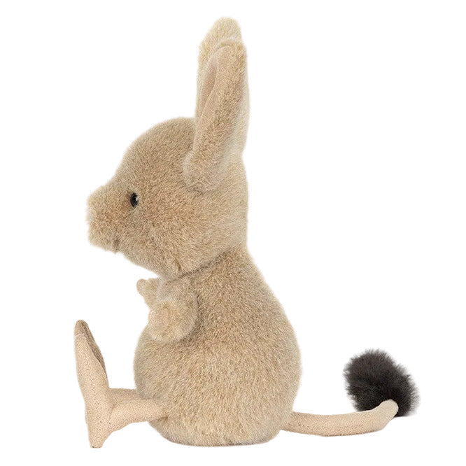 The Jellycat Jerboa is a plush toy featuring large ears, a round body, short limbs, and a long fluffy-tipped tail, shown in profile on a white background—perfect for cuddling.