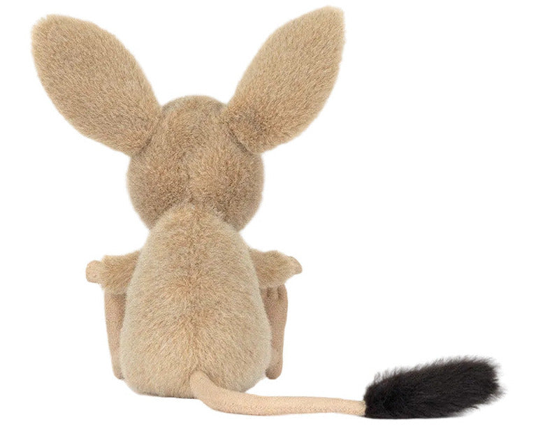 The Jellycat Jerboa plush is shown from behind, displaying large upright ears, a long tail, and a black-tipped tail end.