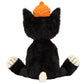 Jellycat Jack Huge, a 24" plush tuxedo cat by Jellycat, sits with legs apart, sporting an orange hat, soft tufty fur, and a small white tail visible from behind.