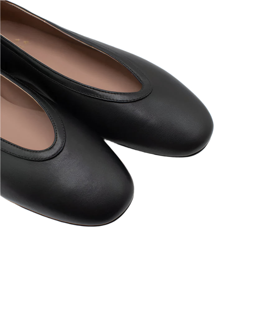 Close-up of Casa Isota's Dafne Leather Flats, crafted from black Nappa leather with rounded toes by Italian artisans, shown on a white background.