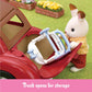 A toy rabbit figure places a folded stroller into the open trunk of the red Calico Critters Family Cruising Car, with a garden setting in the background. Text below reads, “Trunk opens for storage.” Perfect for adventures around Calico Village, the Family Cruising Car keeps all your essentials close at hand.