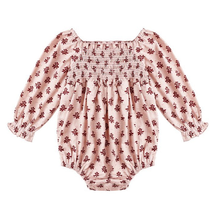 The Baby Girls' Adelaide Romper by Rylee & Cru features a light pink fabric with red floral print, smocked bodice, puffed sleeves with elastic wrists, and a gathered neckline.