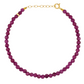 The Jia Jia Birthstone Bracelet by Jia Jia, featuring semi-precious gemstones and a 14-karat gold chain and clasp, is displayed in a circular shape against a white background.