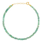 The Jia Jia Birthstone Bracelet by Jia Jia is adorned with small, greenish-blue, semi-precious gemstones and is finished with a gold clasp.