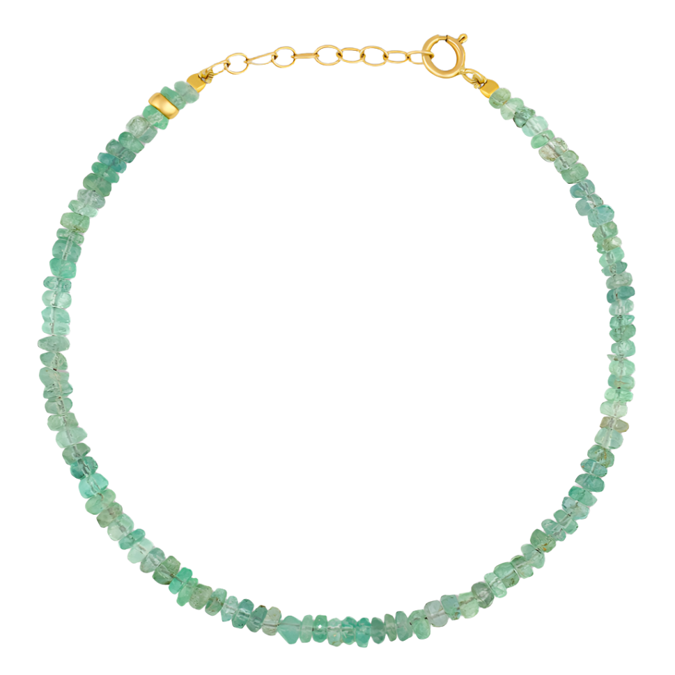 The Jia Jia Birthstone Bracelet by Jia Jia is adorned with small, greenish-blue, semi-precious gemstones and is finished with a gold clasp.