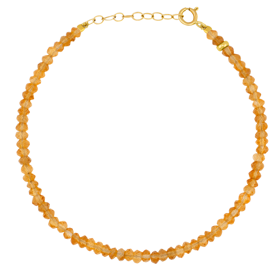 A bracelet featuring a strand of orange, faceted semi-precious gemstone beads with a 14 karat gold clasp and adjustable chain, from the Jia Jia Birthstone Bracelet collection by Jia Jia.