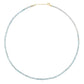 The Jia Jia Birthstone Necklace from the brand Jia Jia is a delicate piece featuring small, light blue semi-precious gemstones and a 14-karat gold clasp.