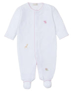 The Kissy Kissy Jungle Mates Hand Emb. Footie is a white baby onesie with long sleeves and footed design, crafted from soft Peruvian cotton. It features subtle pink trim and embroidered animals like a giraffe, elephant, and turtle, perfectly capturing Kissy Kissy's signature charm.