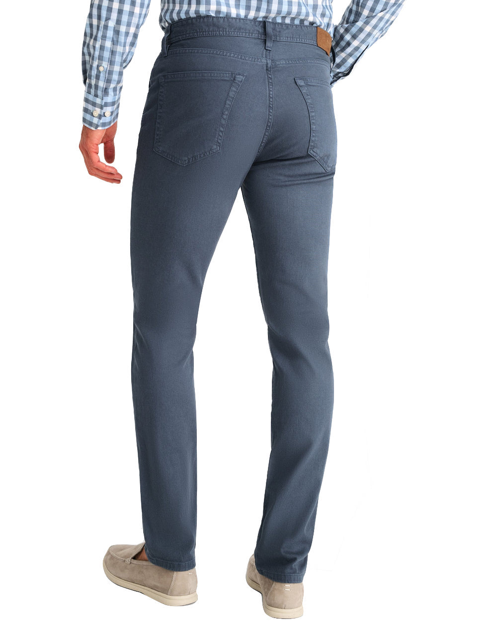 Man in Johnnie-O Hugo Pants and a checkered shirt viewed from the back, with a focus on the denim's fit and details.