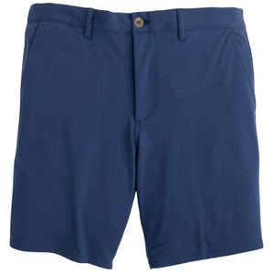 The Johnnie-O Jupiters Stretch Cotton Performance Shorts are blue, knee-length men’s shorts with a button and zipper closure, front pockets, and belt loops. Comfortable and stylish, they’re crafted from performance fabric and shown against a white background.