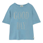 The Cozmo Boys' Good Day T-Shirt is a light blue slub cotton tee featuring "GOOD DAY." in large, light-colored letters on the front—short sleeves and lightweight comfort make it perfect for everyday wear.
