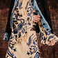 A person wearing the Johanna Ortiz Ritmo Sol Top stands in front of a brown textured background.