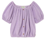 Cozmo Girls' Judy Terry Top in lavender—a short-sleeve blouse with a gathered neckline, button-down front, cropped silhouette, and elastic hem—displayed against a white background.