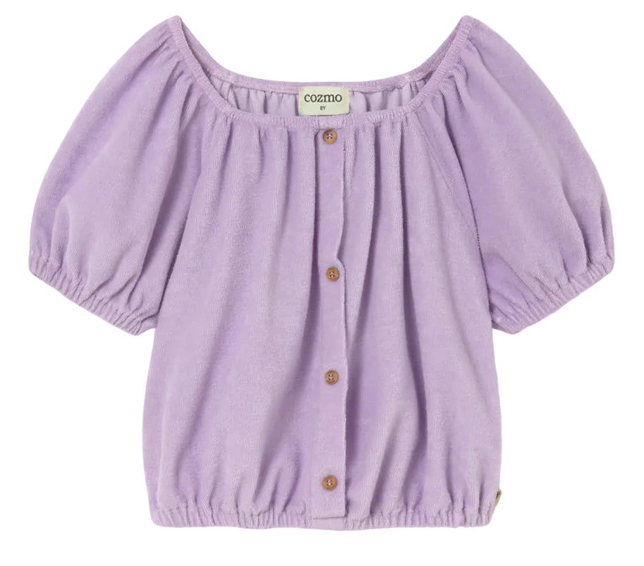 Cozmo Girls' Judy Terry Top in lavender—a short-sleeve blouse with a gathered neckline, button-down front, cropped silhouette, and elastic hem—displayed against a white background.