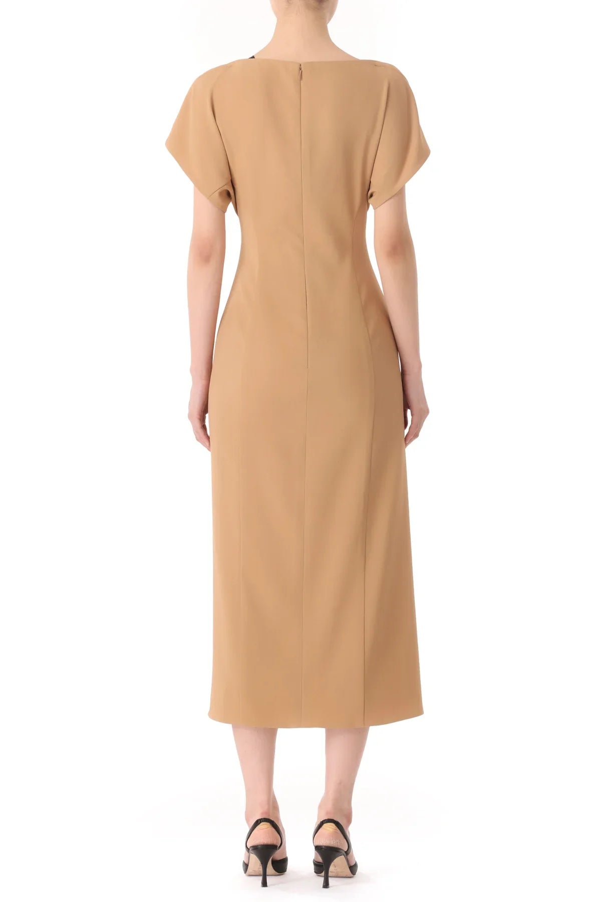 A person is wearing a beige, short-sleeved Jason Wu Collection Draped Neck Fluid Crepe Dress that falls to mid-calf length and black high-heeled sandals, standing with their back to the camera.