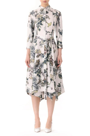 Person wearing a white Jason Wu Collection Forest Floral Silk Twill Shirtdress with a floral and bird print, three-quarter-length sleeves, and a tie belt, standing against a plain white background. White high heels complete the outfit.