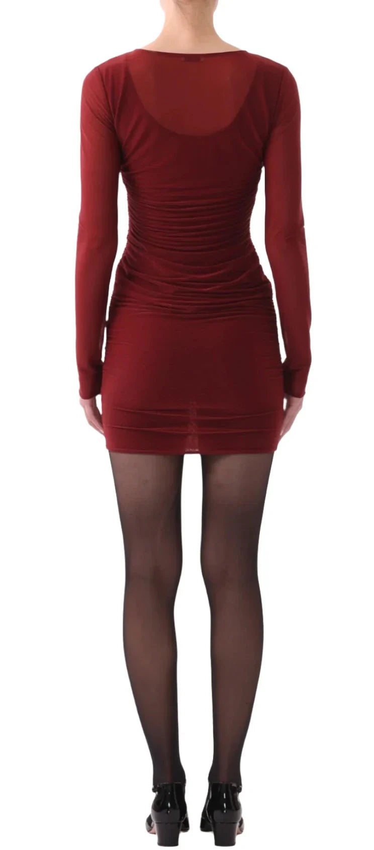 A woman is standing with her back to the camera, wearing a Jason Wu LS Double Layer Ruched Dress in burgundy, paired with black tights and black shoes.