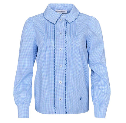 The James Shirt by Hunter Bell NYC is a light blue, long-sleeve button-down with a Saltwater Check gingham pattern, scalloped collar, and decorative trim on the front placket.
