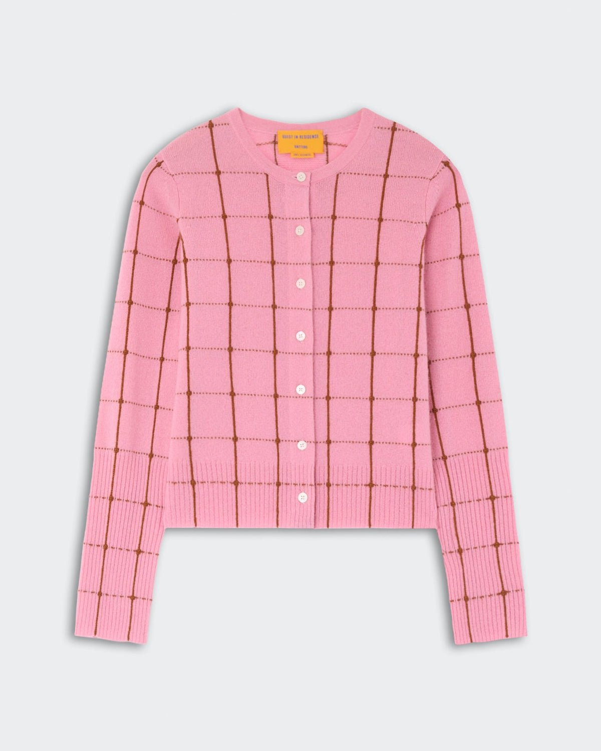The Jane Checker Cardigan by Guest in Residence is a pink, long-sleeve, button-up cashmere cardigan with a brown windowpane check, shown on a light background.