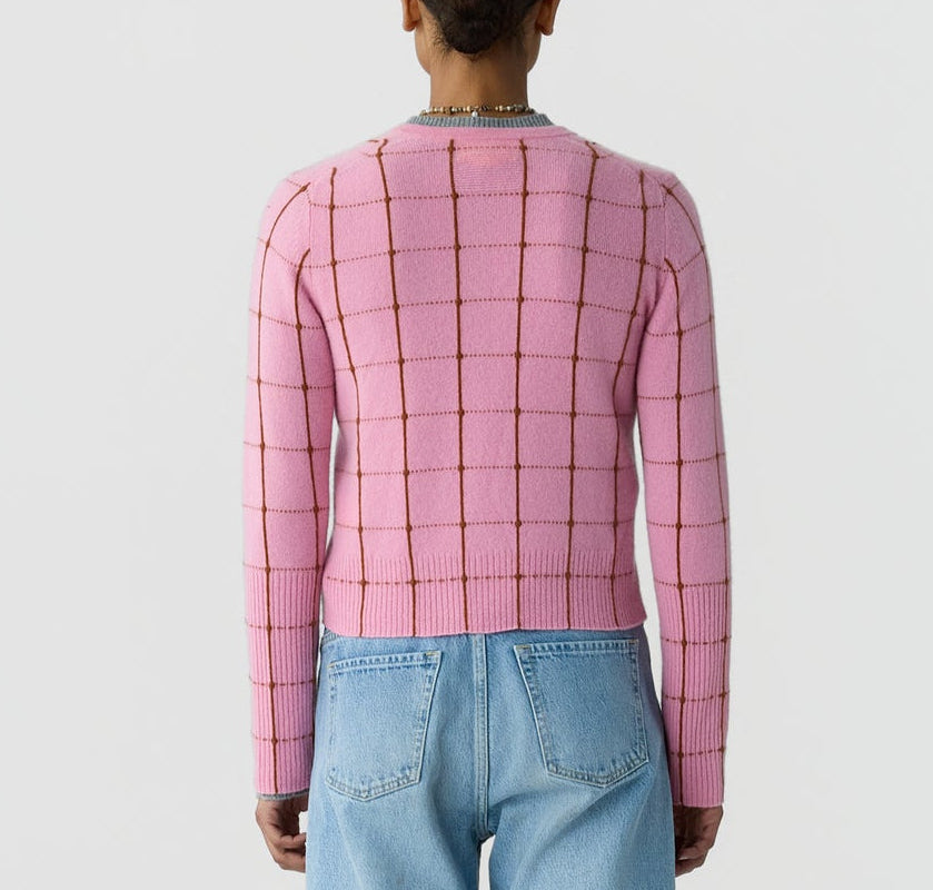 Person wearing the Jane Checker Cardigan by Guest in Residence in pink and light blue jeans, shown from the back against a plain white background.