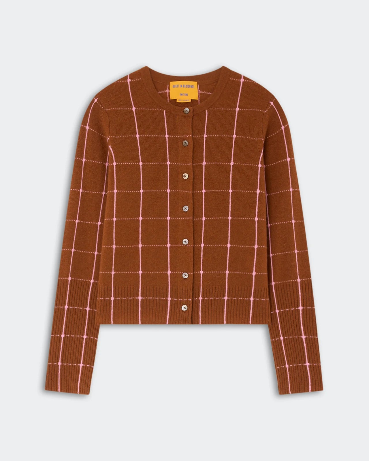 The Jane Checker Cardigan by Guest in Residence is a lightweight cashmere women’s long-sleeve cardigan in brown, featuring a pink windowpane check pattern, front buttons, and ribbed cuffs and hem, displayed on a flat white background.
