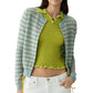 A person wearing the Guest in Residence Pebble Stripe Jane Cardigan in light blue and beige over a green textured top, paired with white pants.