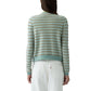 A person with long brown hair, facing away, wears the Guest in Residence Pebble Stripe Jane Cardigan in light blue and beige with white pants. The background is white.