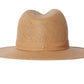 A beige, wide-brimmed, packable Janessa Leone Simone fedora hat isolated on a white background.