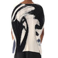 An individual is seen from behind wearing a Jason Wu Collection Boatneck Pleated Square Top with abstract black and white patterns reminiscent of Tong Yang Tze artwork.