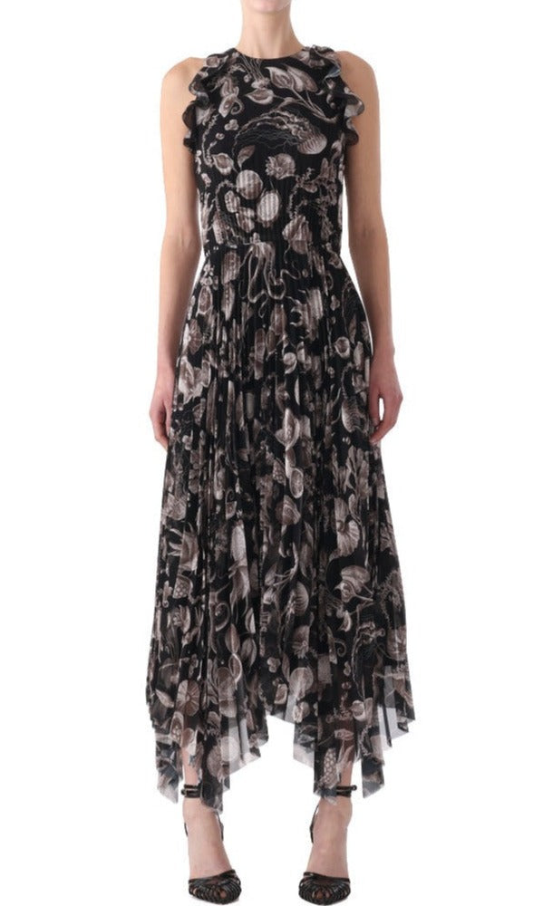 Person wearing a sleeveless, black Jason Wu Collection Pleated Chiffon Dress with a floral pattern and ruffled details, paired with black open-toe shoes.