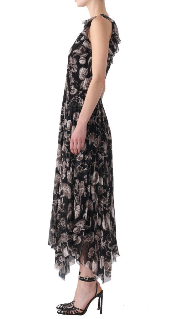 A woman is shown in profile wearing a floor-length, sleeveless, black and white floral Jason Wu Collection Pleated Chiffon Dress paired with black high heels from the Jason Wu Collection.