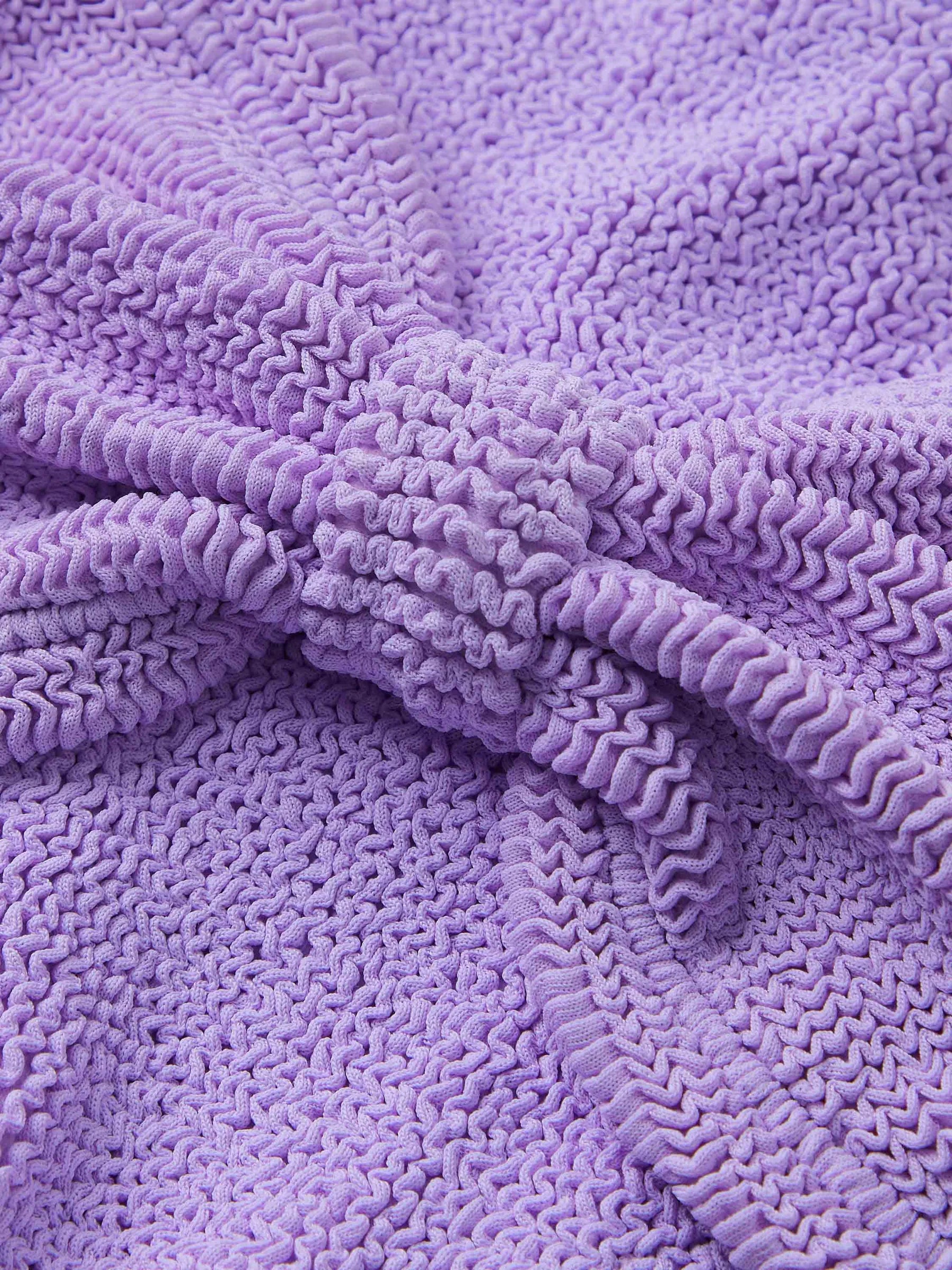 Close-up of the Hunza G Jean Bikini’s textured lavender fabric featuring a central gathered knot, with distinctive ruched and crinkled details—ideal for strap-free swimwear in a one size fits all design.
