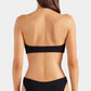 A woman stands with her back to the camera, wearing the Hunza G Jean Bikini—a black crinkle fabric bandeau bikini top with matching bottoms—against a plain white background.