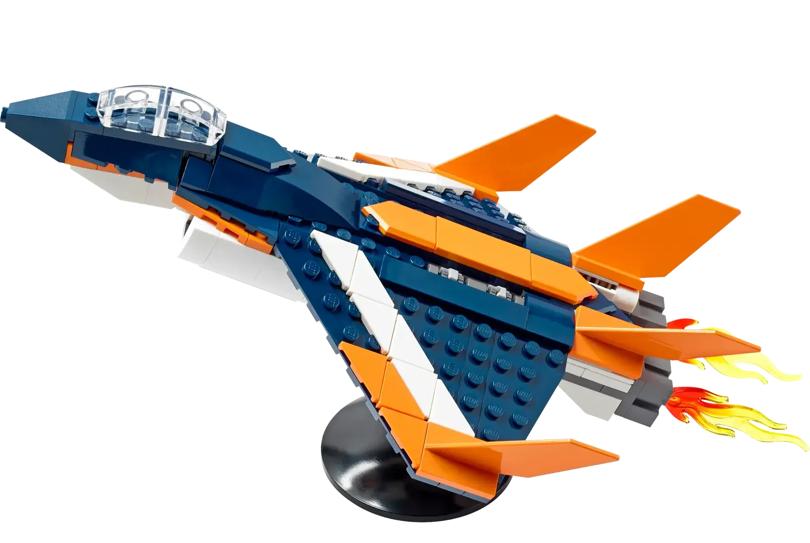 The LEGO® Creator Supersonic Jet from Legos - Toyhouse is displayed on a stand, showcasing its vibrant orange fins and a visible flame at the rear.