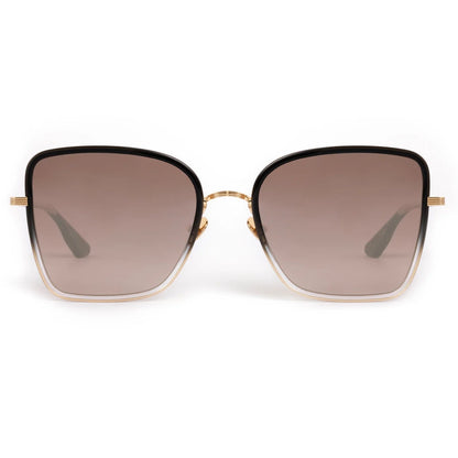 The Jolene Sunglasses by Krewe feature a front view of oversized square lenses with a gradient brown tint and thin gold frames.