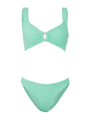 The Julia Bikini by Hunza G features a light green, ocean-inspired textured design with a pearly hoop detail at the center of the top and matching high-cut bottoms, shown against a white background.