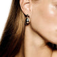 Close-up of a person with straight brown hair wearing the LIÉ STUDIO Julie Earrings from Lie Studio, which are shiny and teardrop-shaped with pearl drops. The skin is smooth and the background is white.