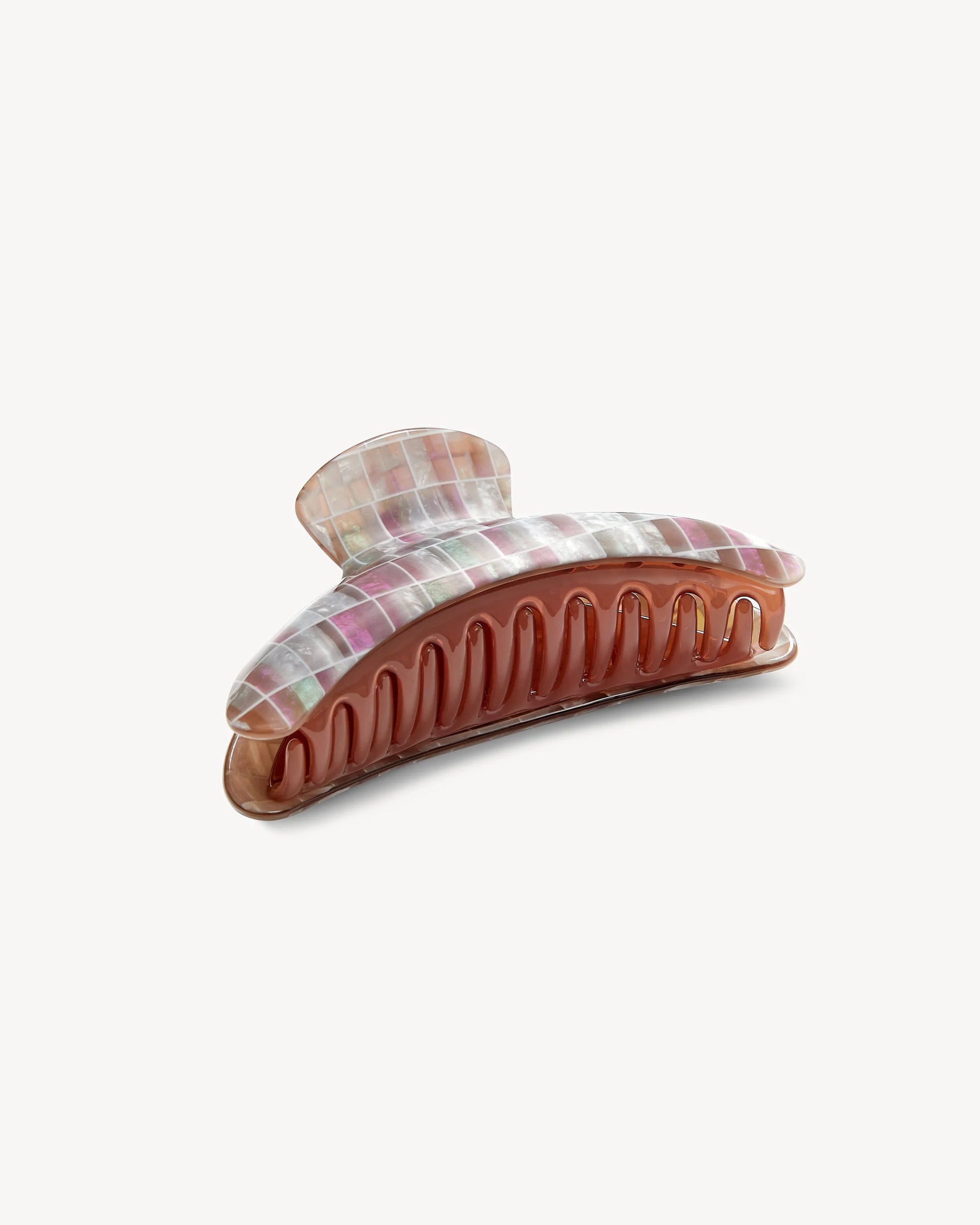 Introducing the Jumbo Heirloom Claw by Machete—a large claw clip made from premium Italian acetate. This plastic hair accessory showcases a marbled pastel top paired with a translucent pink base, making it ideal for securing thick hair. Shown against a plain white background.