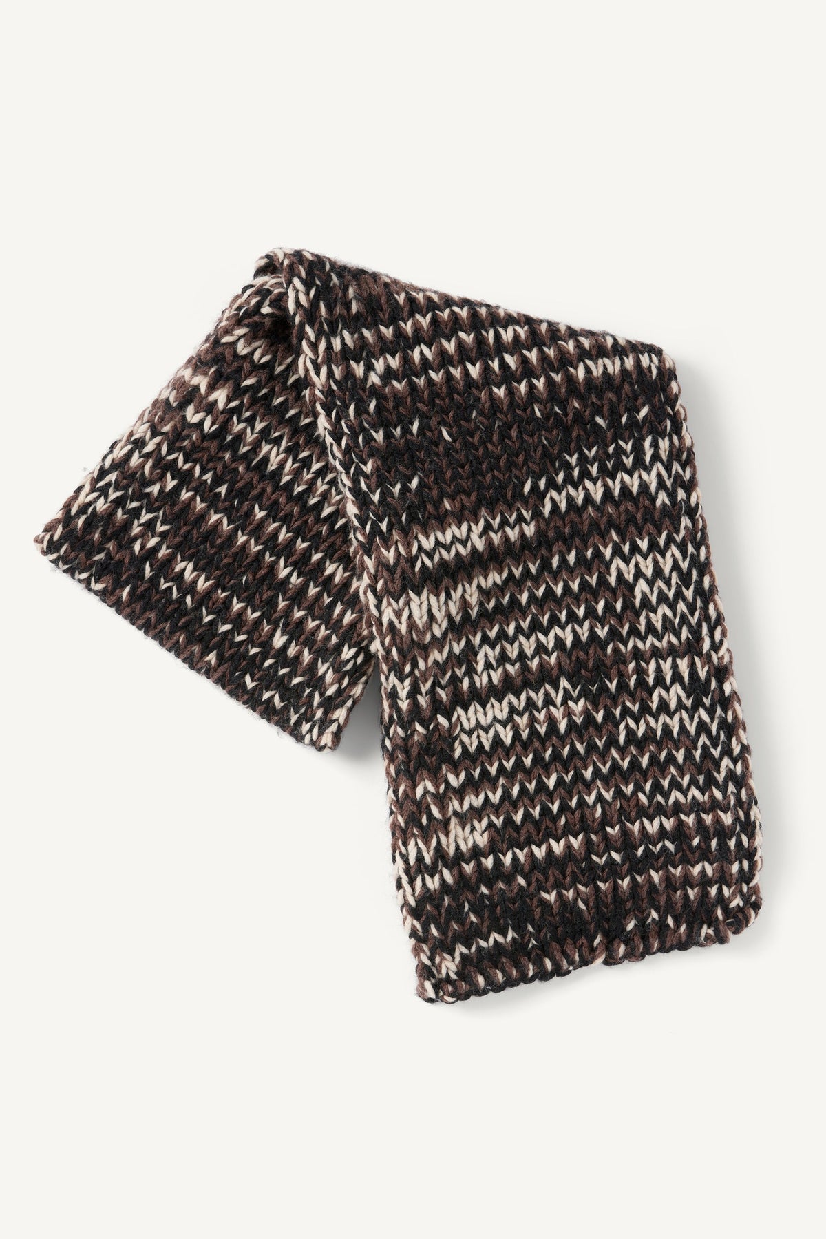 Folded chunky knit Kiva Scarf featuring a multi-colored pattern of brown, black, and cream yarn.