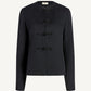 The Tilda Jacket by Kallmeyer is a black Grampians Twill long-sleeve style with a collarless neckline and four decorative knotted fastenings down the front, featuring a chic peplum silhouette for added elegance.