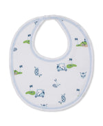 The Kissy Kissy Golf Championship Prt. Bib is made from white Pima cotton with light blue trim and decorated with a playful golf-themed print in blue, green, and light pink.
