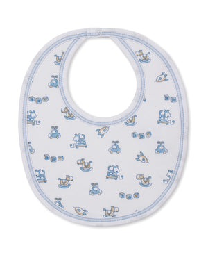 Introducing the Vintage Toy Fun Bib by Kissy Kissy—a white Pima cotton baby bib with blue trim, featuring delightful blue and beige illustrations of rocking horses, cars, blocks, and elephants for a charming vintage toy look.