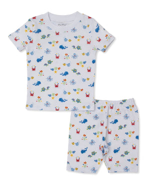 The Kissy Kissy Baby and Kids' Ocean Antics Short Sleeve PJ Set showcases a delightful ocean-themed print with vibrant crabs, fish, turtles, and whales on a clean white background. Crafted from ultra-soft Pima cotton, these pajamas are as cozy as they are charming for your little one.