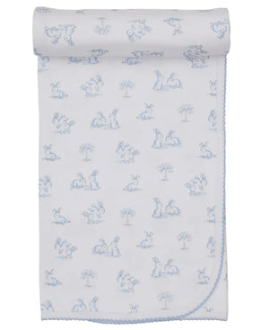 The Kissy Kissy Springtime Bunny Fun Blanket is a white Pima cotton baby blanket with blue bunny and tree illustrations, finished with scalloped trim.