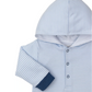 The Kissy Kissy Rambling Railroad Hooded Playsuit, by Kissy Kissy, features a baby blue and white striped design with blue cuffs and buttons. Made from soft Pima cotton, it ensures comfort for your baby's delicate skin.