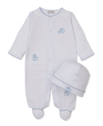 Kissy Kissy Baby Sweet Sheep Footie with Hat Set in white, featuring long sleeves, delicate blue sheep prints, soft blue trim, and a matching white hat. Both pieces are crafted from luxurious Pima cotton for extra comfort and laid flat on a white background.