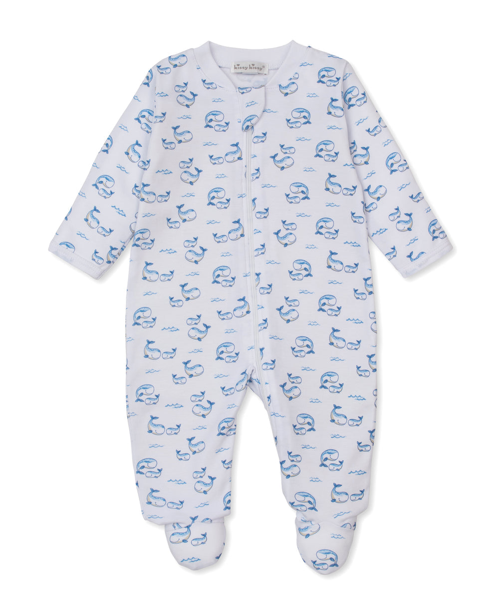 Introducing the Baby Whale Pods Zip Footie by Kissy Kissy—a white baby sleeper adorned with an adorable whale pods print. Designed with long sleeves, footed legs, and a convenient front zipper closure, this cozy footie is crafted from ultra-soft Pima cotton for ultimate comfort.
